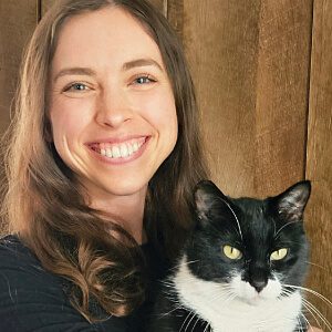 female holding a black and white cat